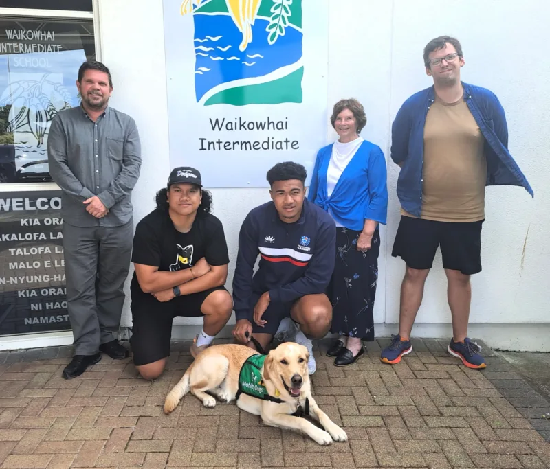 A group of 5 teachers with Milo the Mobility Dog