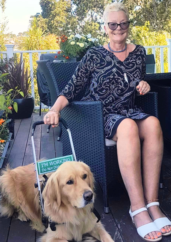 A woman sitting in a chair with her service dog